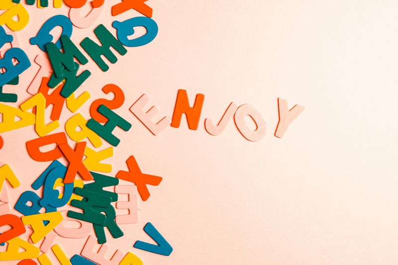 Scattered colourful wooden letters spelling out words