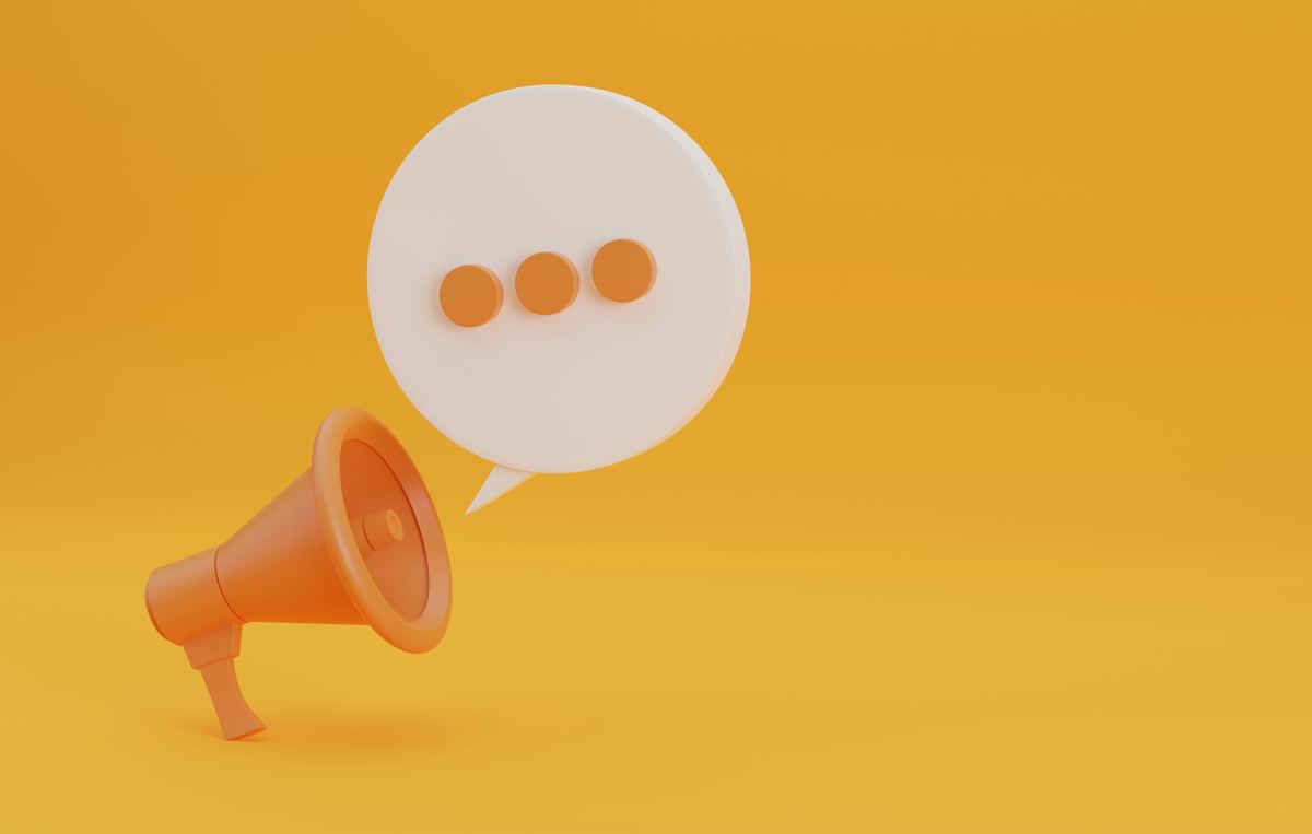 An orange megaphone with a speech bubble on a yellow background